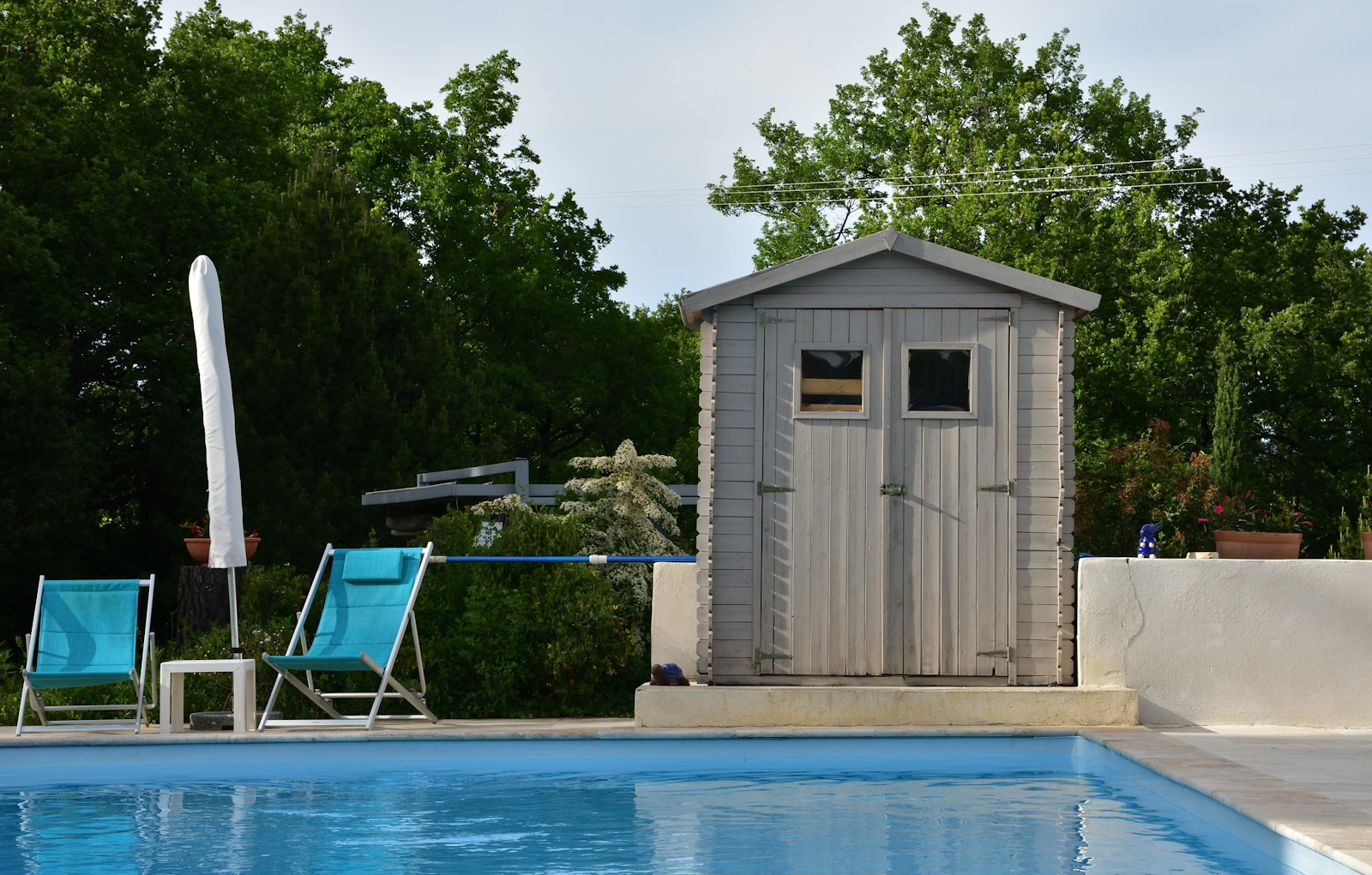 a pool with a small shed next to it